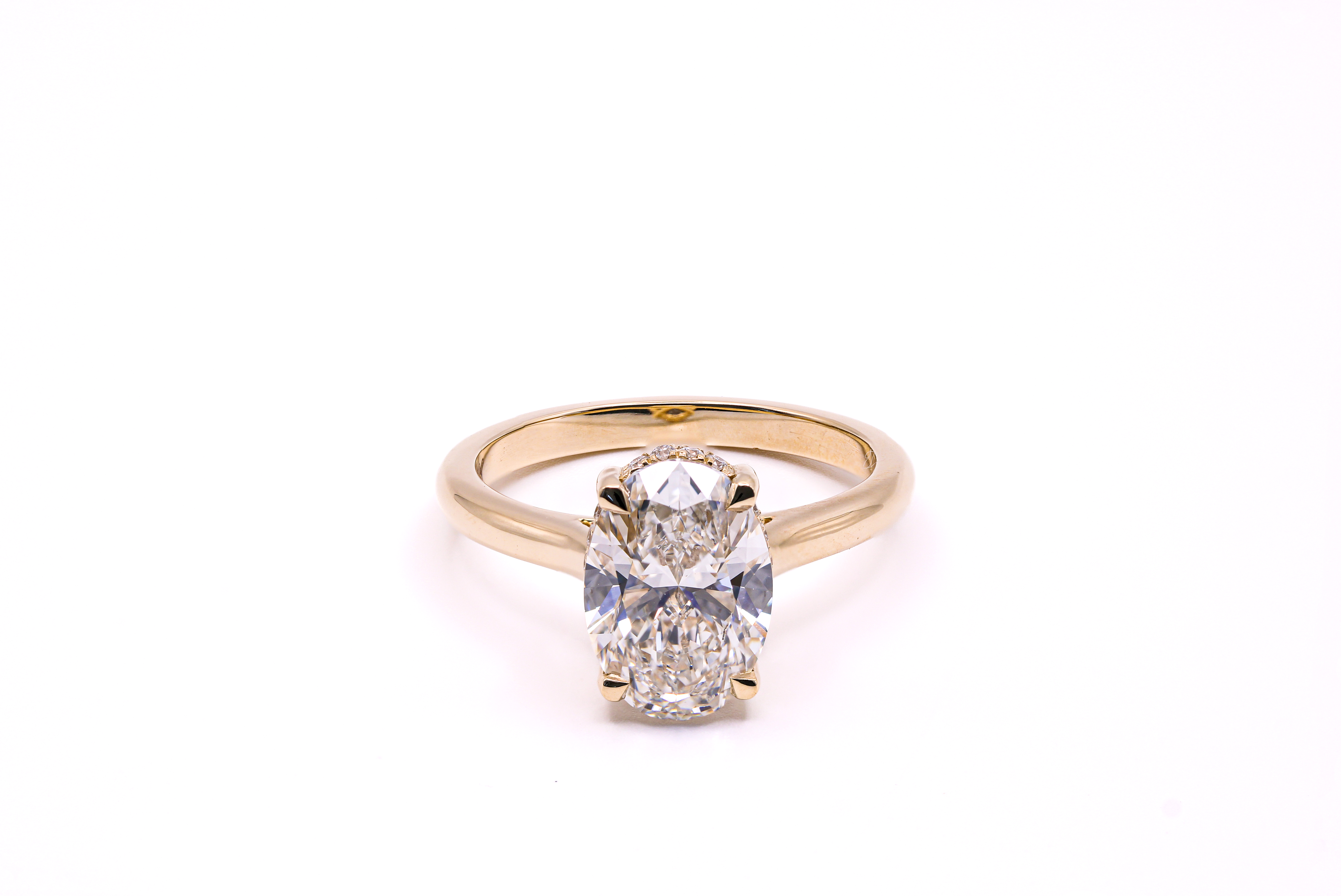 Oval hidden halo engagement ring front view